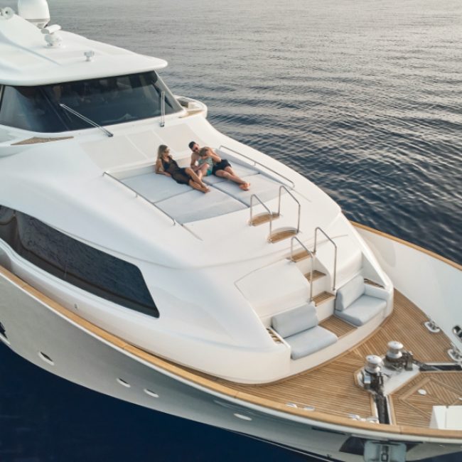Navetta 26 Friend's Boat_Aerial view close up with couple on lounges 2_YACHT IN